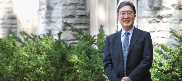 Dean Michael Kim standing in front of Talbot College at Western University