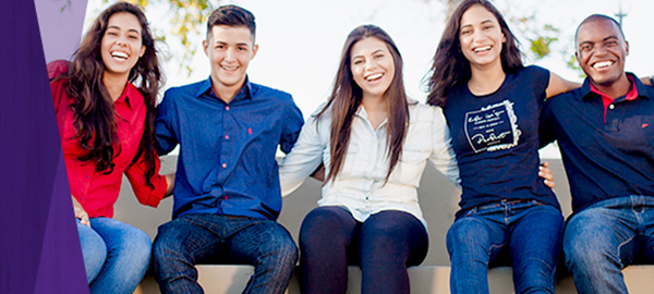 Three women and two men smiling.