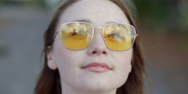 A student looking up with yellow sunglasses on
