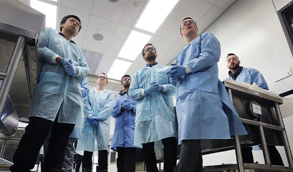 Group of medical students in scrubs and surgical gowns