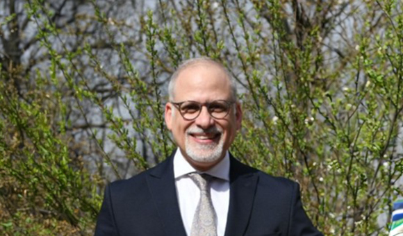 Dr. Wael Haddara pictured outside in front of blooming trees
